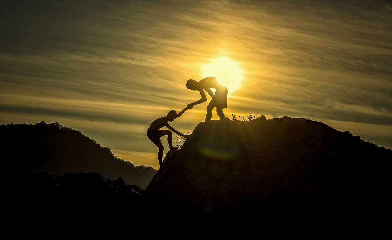 climber helping up a mountain